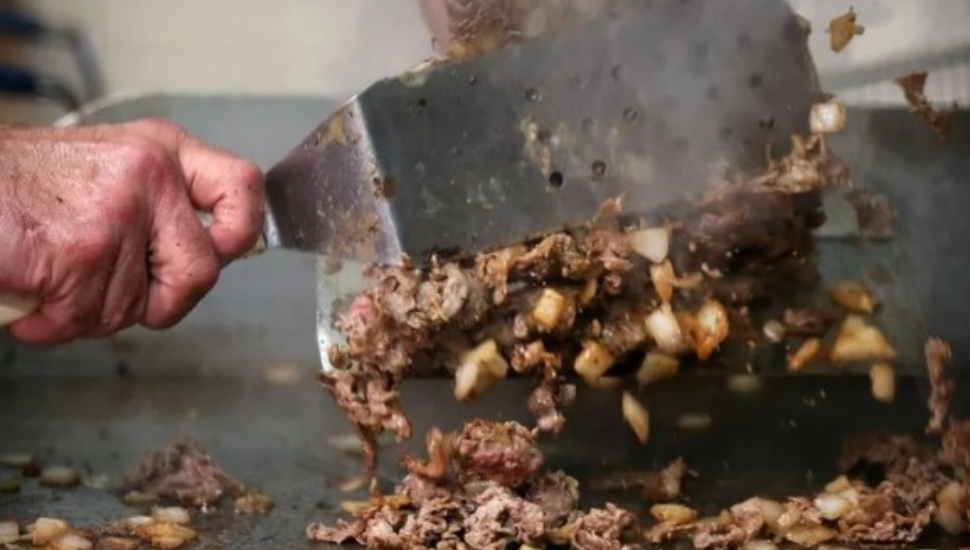 A cheesesteak on the grill