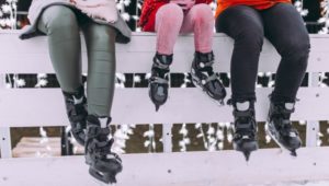 Three legs handing down wearing ice skates