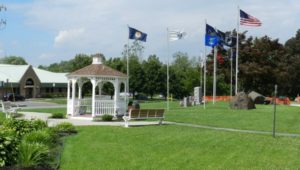 A gazebo with some flags in a local park.