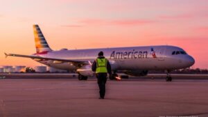 Philadelphia Airport worker walking toward an American Airlines jet.
