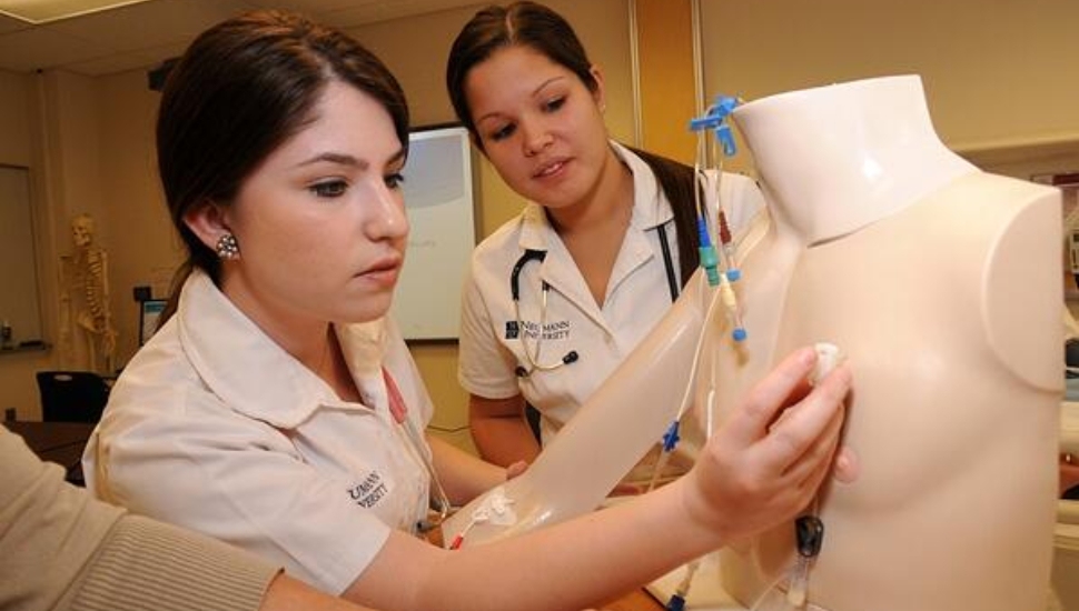Two student nurses at Neumann University.