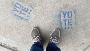 feet on a sidewalk highlighting the redistricting debate.