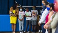 Principal Brooke Vaught at Hancock Elementary School stands with students at a press conference with Pa. Gov. Tom Wolf.