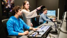 Neumann University students in a broadcast control room on campus.