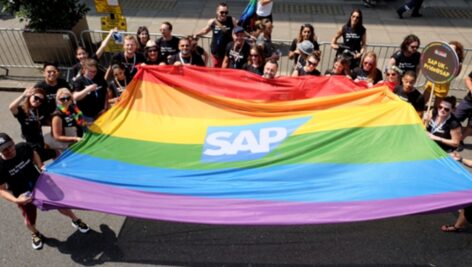 A group from SAP holding a rainbow flag.