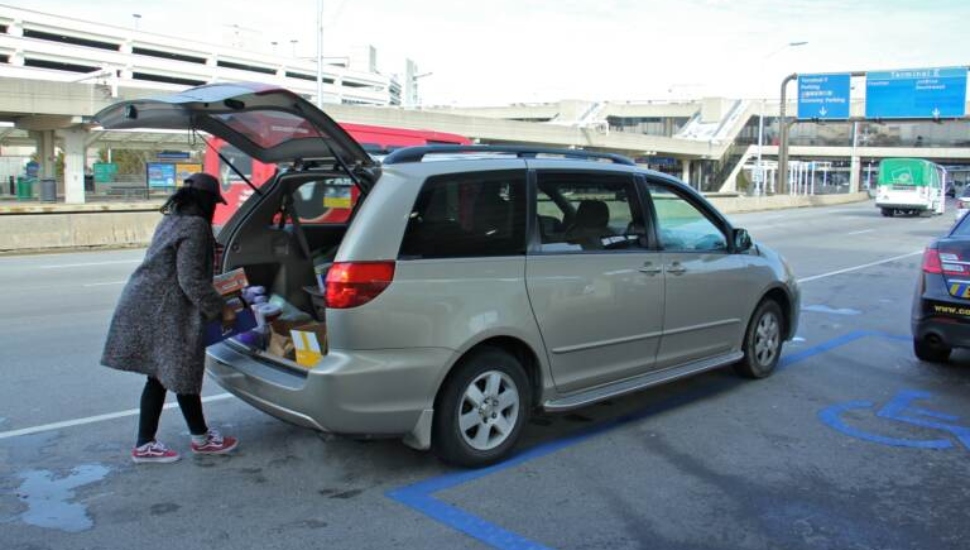 Woman parking and unloading at Philadelphia Airport.