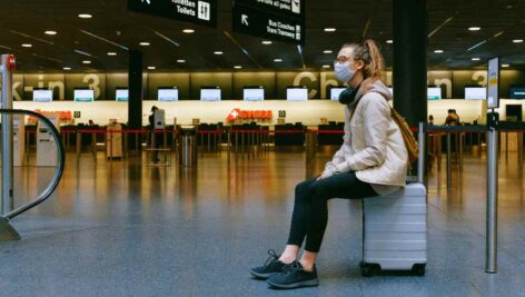 woman sitting on suitcase