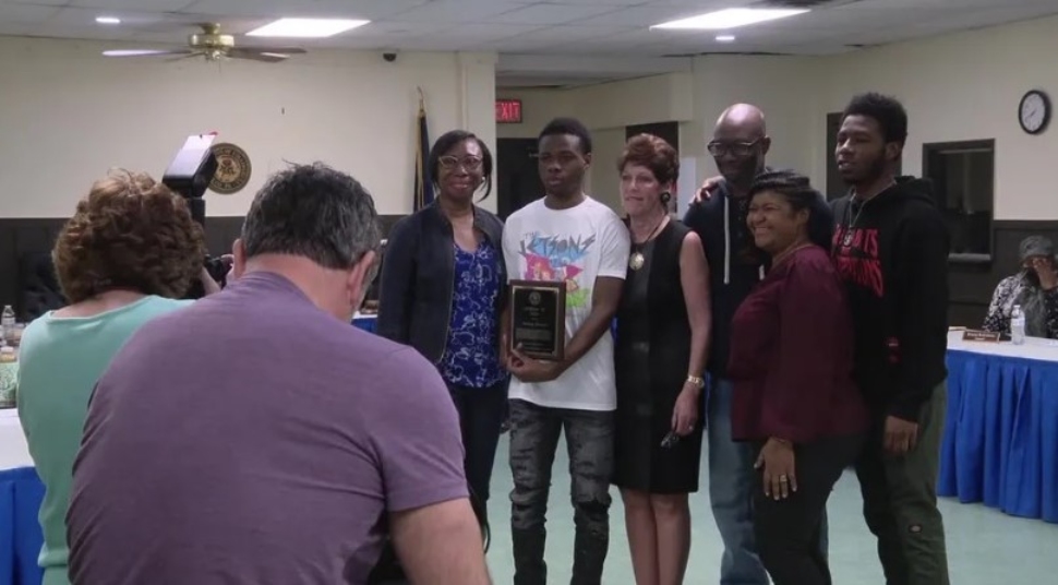 Anthony Alexander with family receiving a certificate fin Collingdale for his pond rescue.
