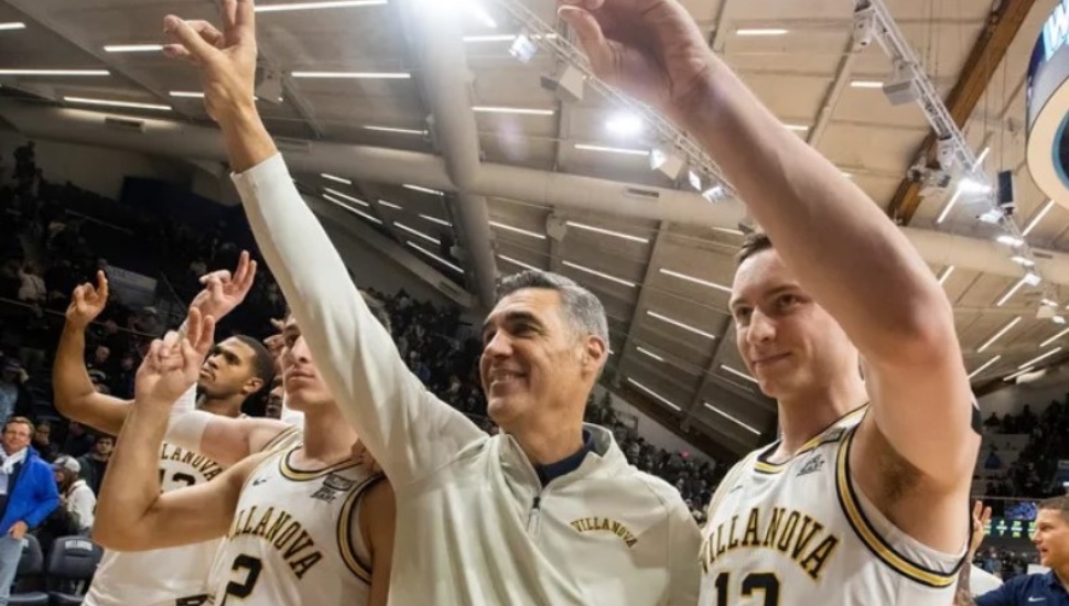 Villanova coach Jay Wright stands with Kevin Voigt (right)