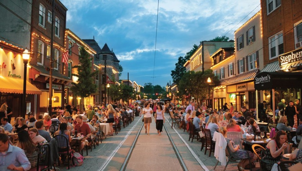 Walkable closed street in Media Borough with tables set up for meals.