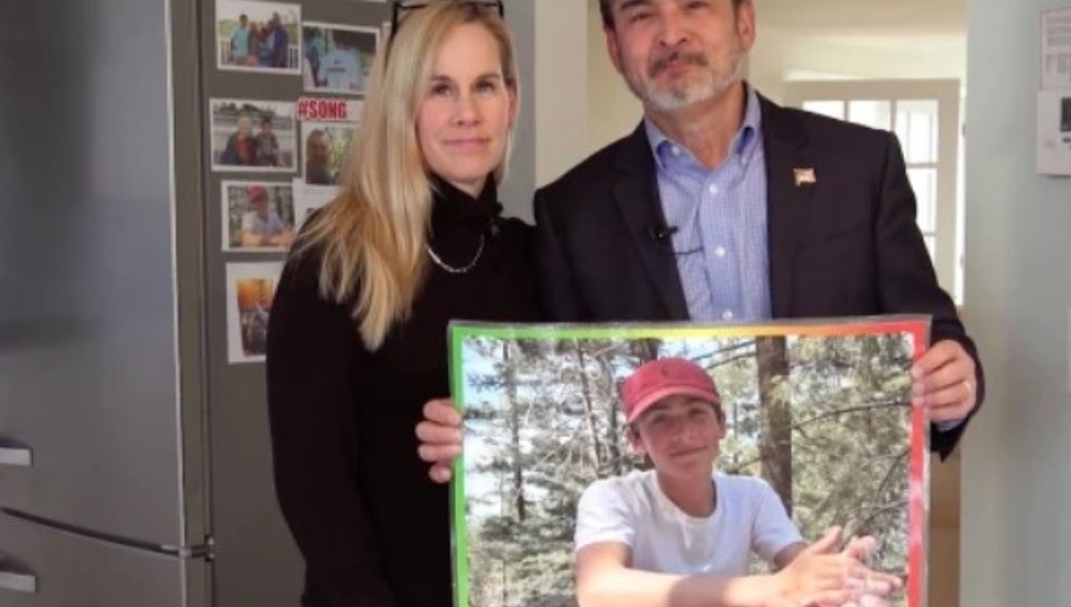 Mike and Kristin Song with a picture of their son, Ethan Song, 15.