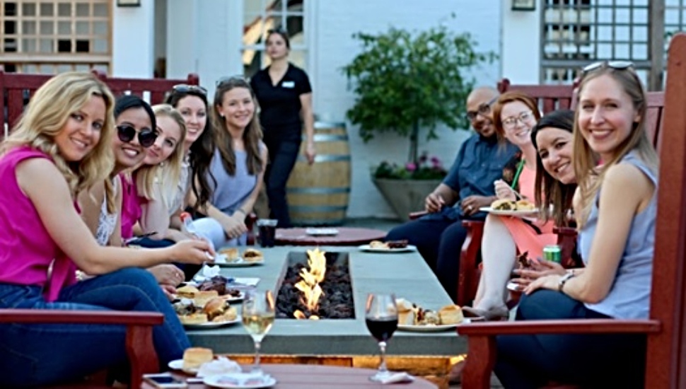 people outside eating fire pit dinner