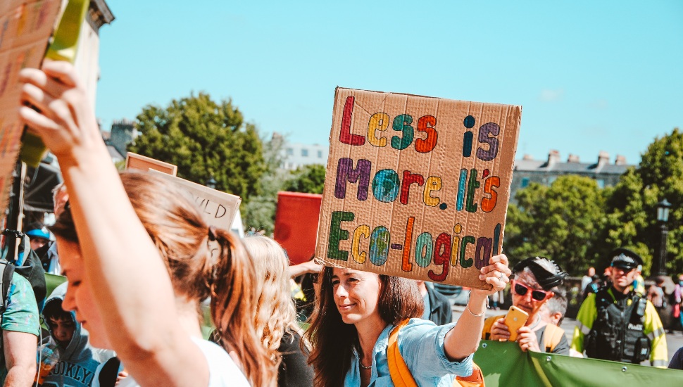Demonstrators with signs calling for zero waste options.