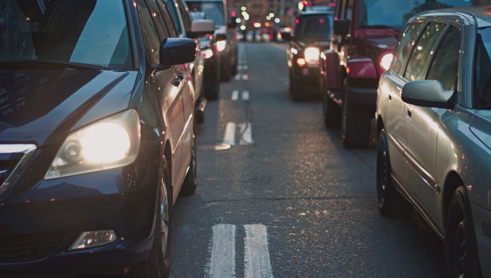 An evening commute with cars stuck in traffic.