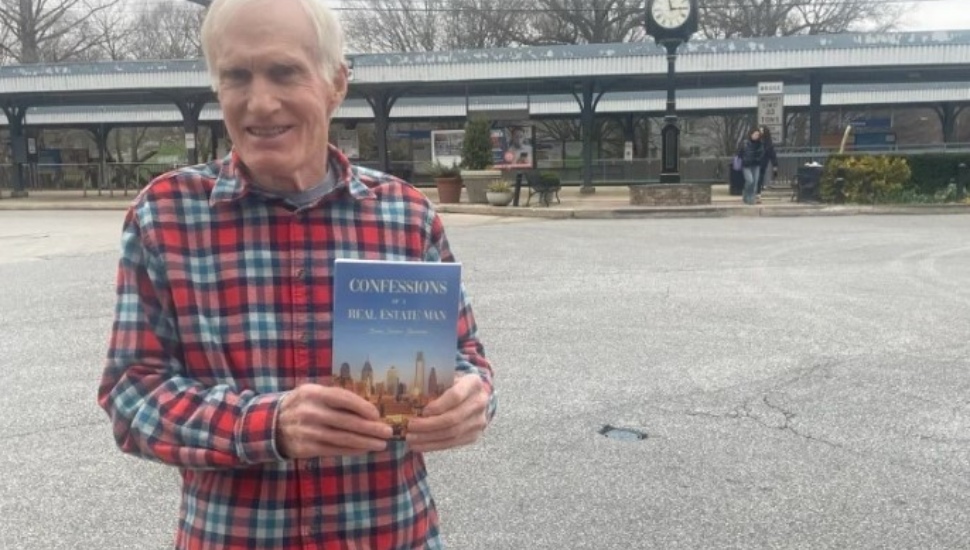 First-time author Brian Barrabee holds up his new book, 'Confessions of a Real Estate Man'.