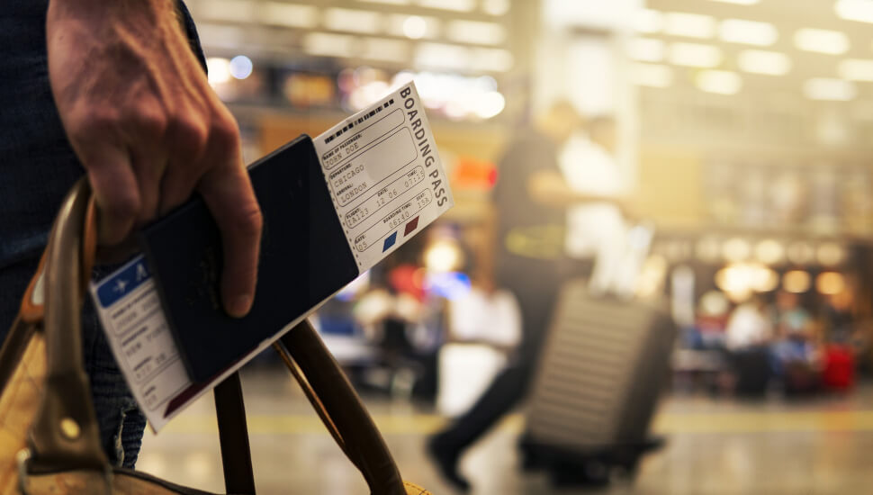 Man carrying a ticket in an airport