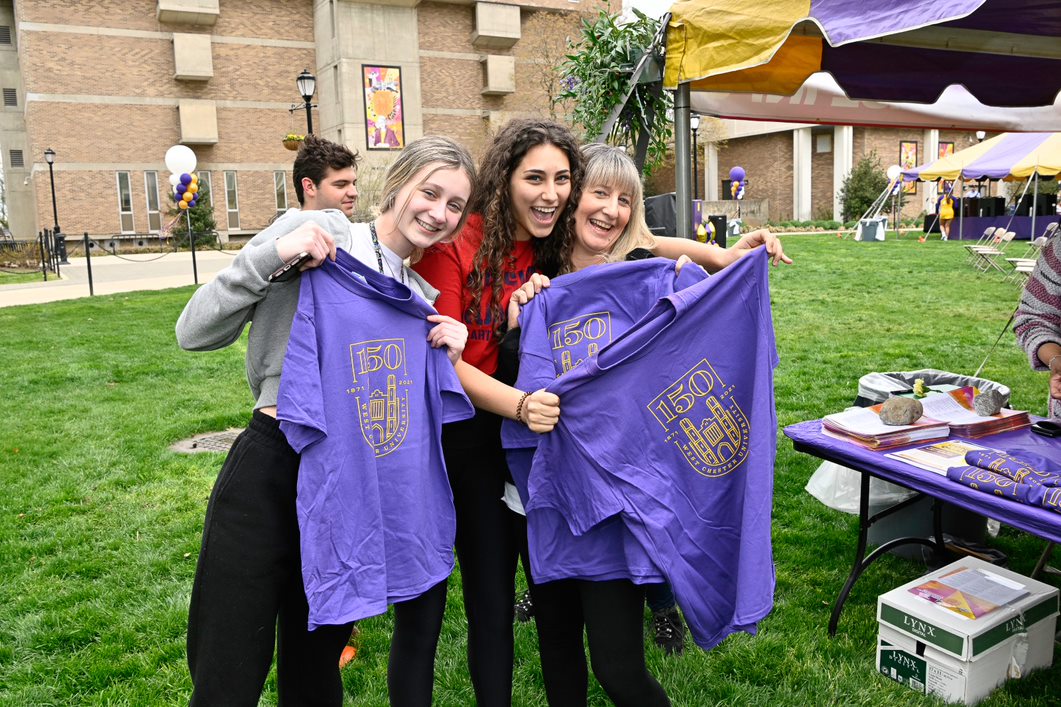 3 Women show off some West Chester University 150th anniversary T-shirts.