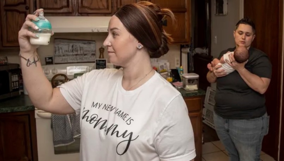 Ashley Brown (front) and Kristen Bradwell prepare infant formula for their month-old daughter, Amelia, in their home in Brookhaven.