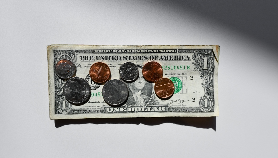 A dollar bill with some change