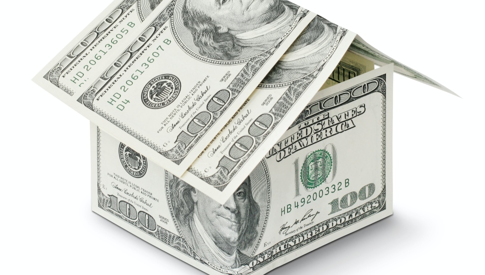 A model of a home made from $100 bills.