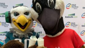 The Eagles and Wawa mascots enjoy a SWOOP shake.