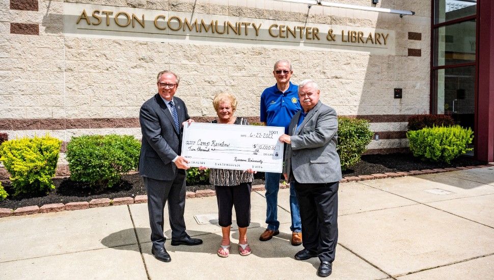 Chris Domes, Nancy Bowden, Fred Prendergast and Les Berry holding a big check for Camp Rainbow.