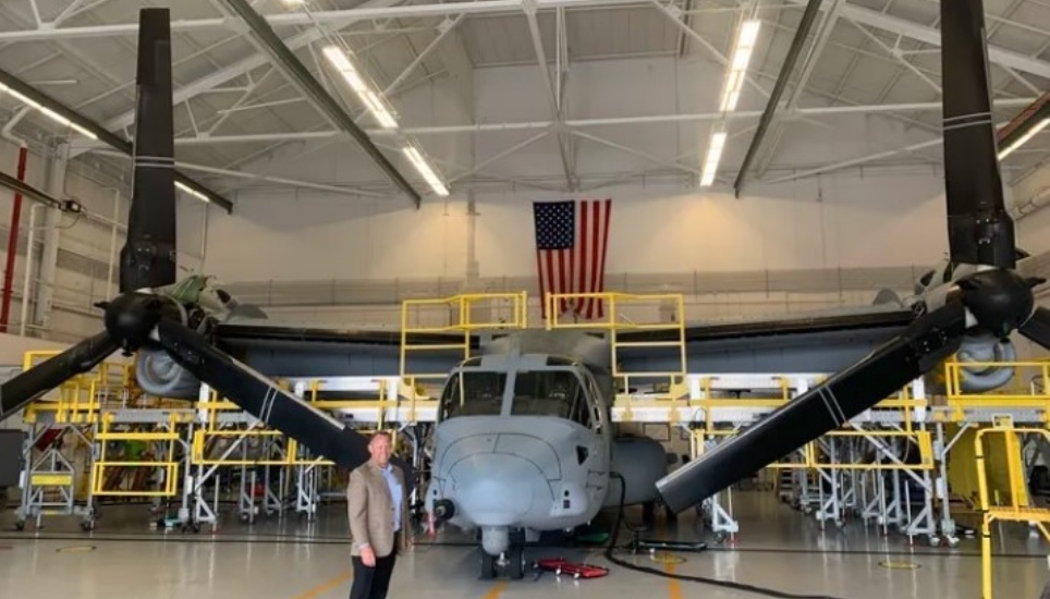 Boeing plant executive Shane Openshaw with a V-22 Osprey.