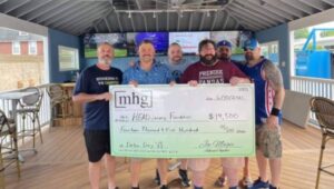 Five men holding a big check at a Delco Day fundraiser