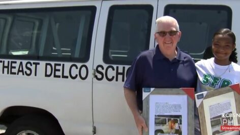 Jim Ruane with Carrington Campbell next to his school van.