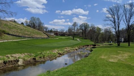 Golf course at Paxon Hollow with a creek and tall grass.
