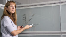 Woman-presenting-in-front-of-a-white-board