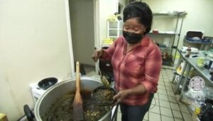 Emma Dalieh prepares a Liberian dish in her restaurant kitchen.