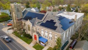 An aerial view of a church in Havertown with rooftop solar panels