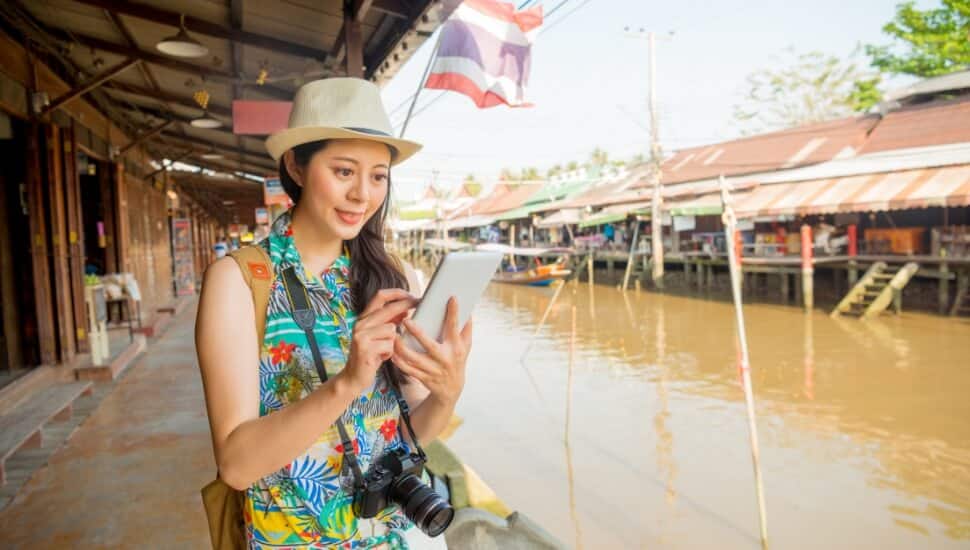 Woman checks her cell phone on vacation