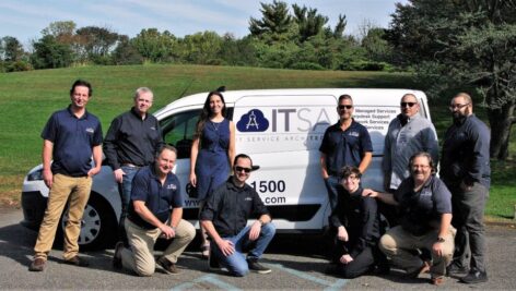 Employees of ITService ArchiTechs LLC standing outside their van. IT Service ArchiTechs is on the Soaring 76 list.