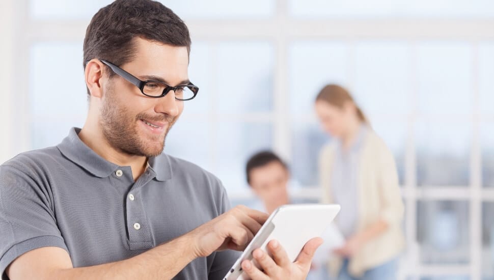 Man in a polo shirt working in an office