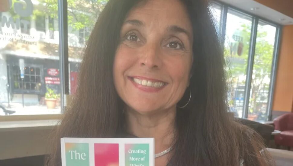 Theresa Agostinelli holding her new book.