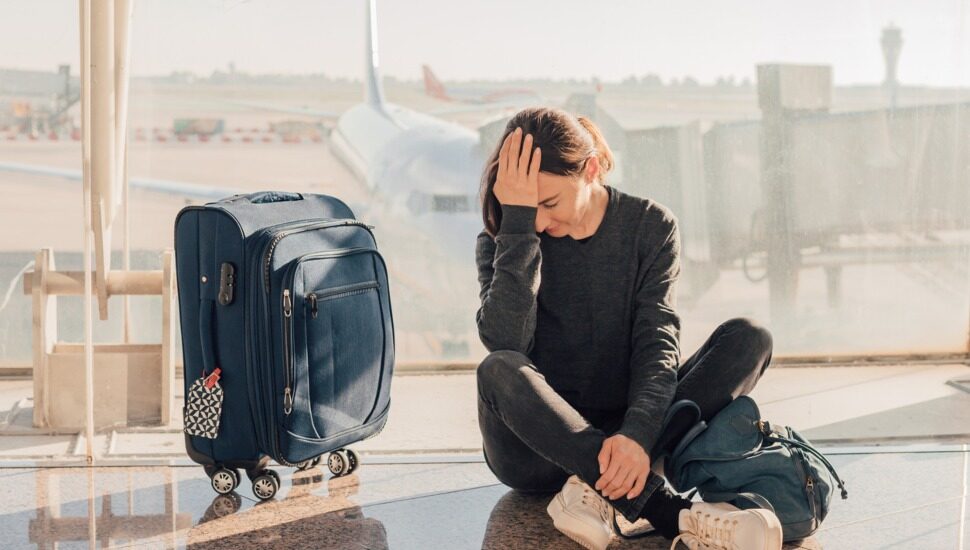 A frustrated woman at the airport after a cancelled flight