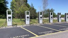 A row of electric vehicle charging stations in a parking lot