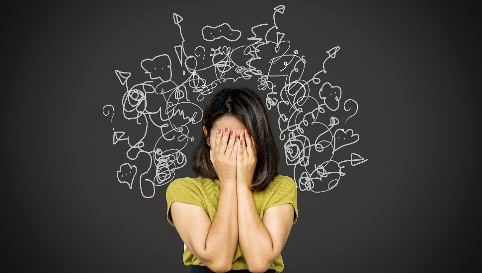 woman with hands over face