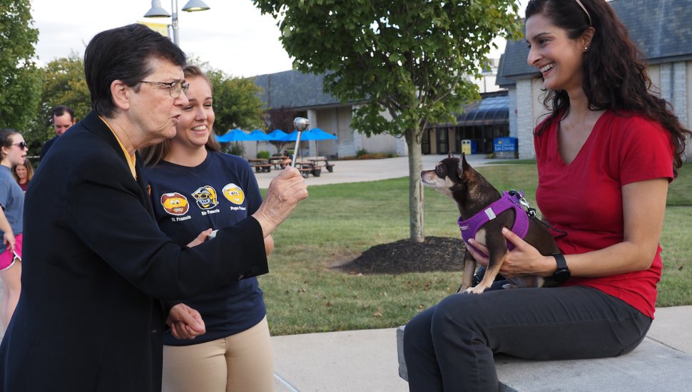 Sr. Marguerite O'Beirne blesses the furry friend of Preeti Singh in 2019.