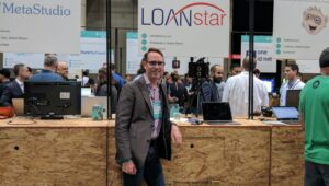 A staff member of LoanStar Technologies at a convention vendor booth