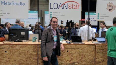 A staff member of LoanStar Technologies at a convention vendor booth