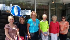 Owner Diane Corbett (third from left) and her staff pose outside Mankind's HeadQuarters, a hair salon in Media