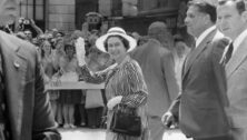 Queen Elizabeth II waves to the crowd in front of City Hall during her 1976 visit .