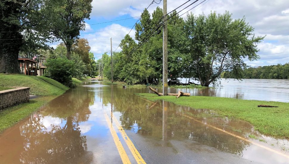 Flood waters overflow on to a roadway