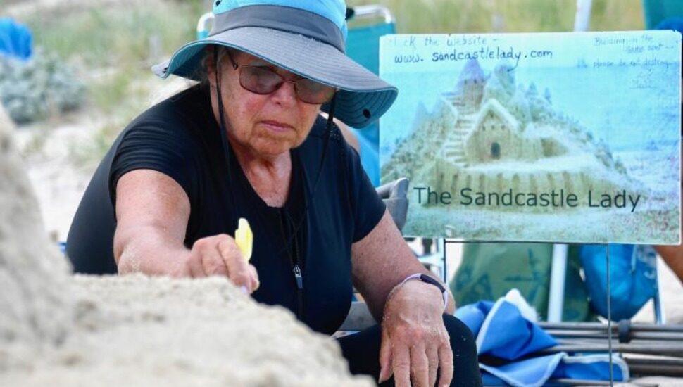 Lynn Hicks McKeown at work on her sandcastle.