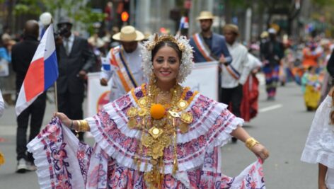 A woman in a parade celebrating National Hispanic Heritage Month