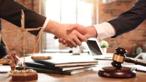 A handshake agreement with an attorney in his office