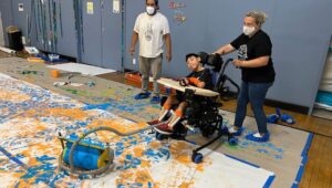 Utilizing special rollers, students were able to add their own personal touches to a CADES mural in Swarthmore